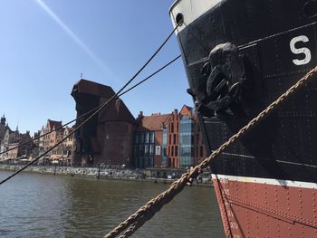 River by buildings in city against sky