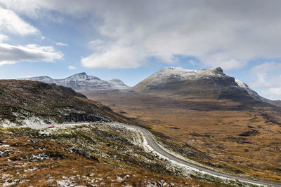 Scenic view of mountains against cloudy sky