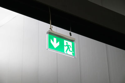 Low angle view of information sign on wall