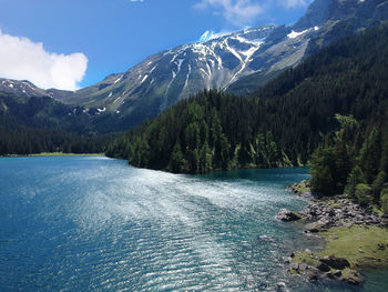 Scenic view of river amidst mountains against sky