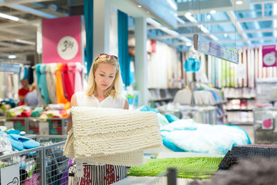 Mid adult woman standing in departmental store