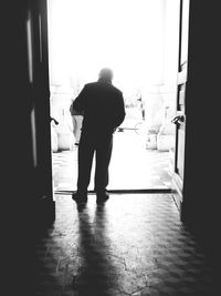 Rear view of woman walking in corridor