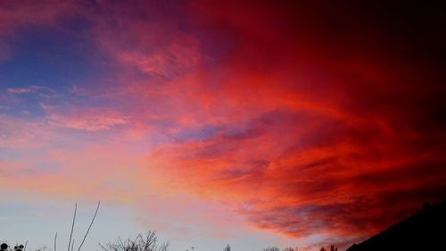 Low angle view of dramatic sky during sunset