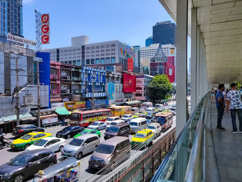 People walking on street against buildings in city