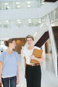 Young women in office building hall