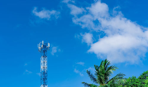 Telecommunication tower with blue sky and white clouds background. antenna on blue sky. 