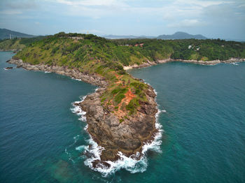 High angle view of sea and rocks against sky