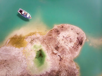 Aerial view of boat on sea during sunny day