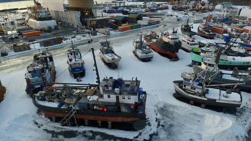 High angle view of boats moored at harbor during winter