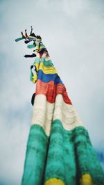 Low angle view of people against blue sky