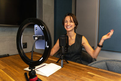 Portrait of young woman sitting on floor at home