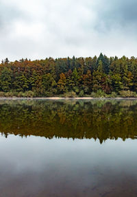 Reflection of trees in lake against sky during autumn