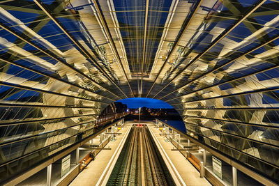 Railroad tracks in illuminated tunnel