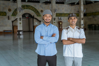 Portrait of smiling men standing at mosque