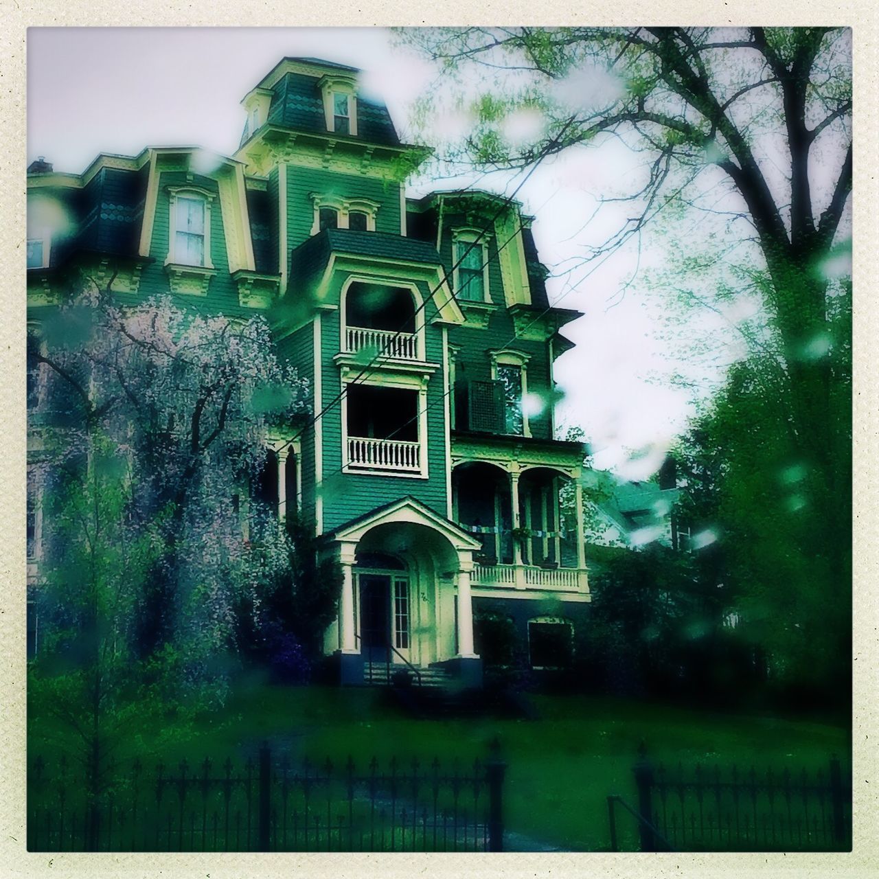 LOW ANGLE VIEW OF BUILDING WITH TREES IN BACKGROUND