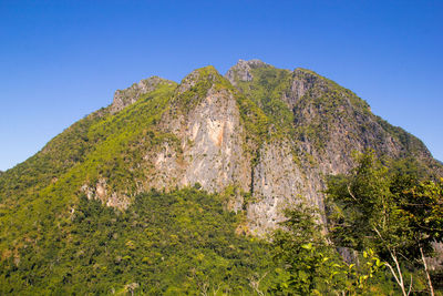 Low angle view of mountain against clear blue sky