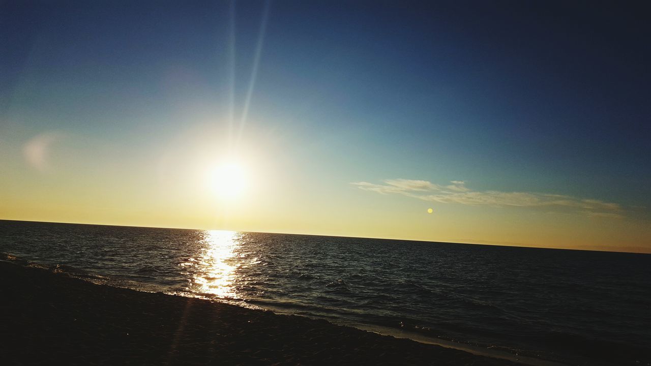 SCENIC VIEW OF SUNSET OVER SEA