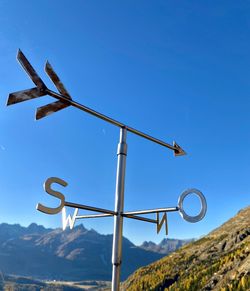 Low angle view of sign against sky
