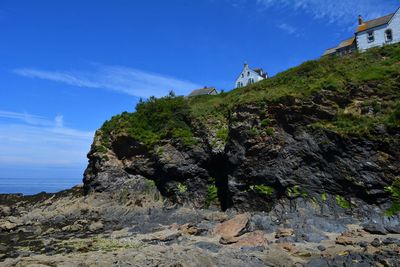 Low angle view of rock formations against sky