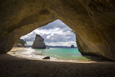 Scenic view of sea seen through cave