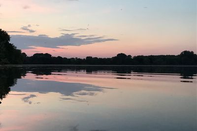 Scenic view of lake against sky at sunset