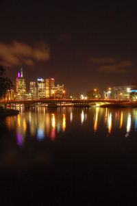 Illuminated city at waterfront