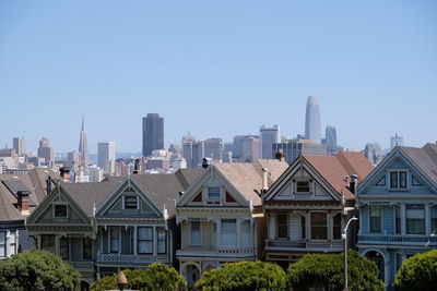 Buildings in city against clear sky