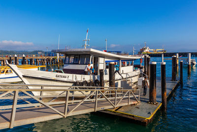 Pier at harbor against blue sky