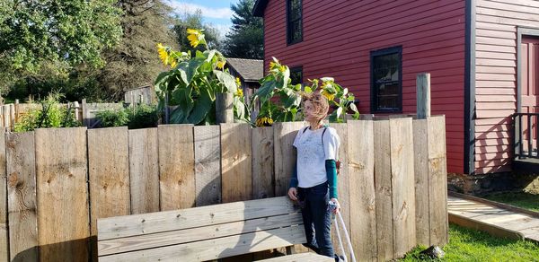 Woman standing by bench