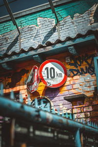 Low angle view of road sign against buildings