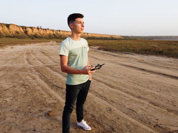 Young man standing on field