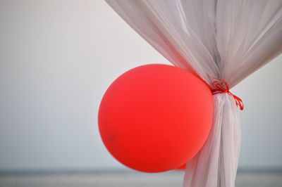 Close-up of red balloons against sky