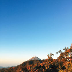 Scenic view of mountains against clear blue sky