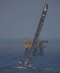 People in sea against clear sky