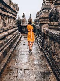 Rear view of man walking in temple