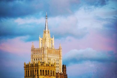 Low angle view of building against cloudy sky