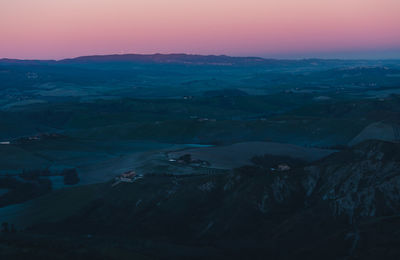 High angle view of snowcapped mountains against sky during sunset