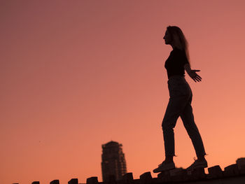 Silhouette man standing against clear sky during sunset