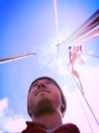 Low angle view of woman against blue sky