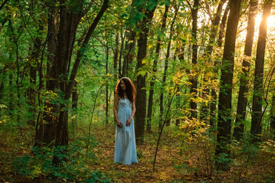 Woman standing in forest