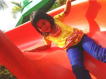 Rear view of smiling girl in playground