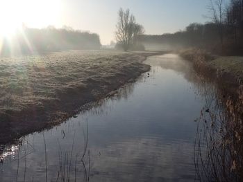 Scenic view of lake against sky during winter