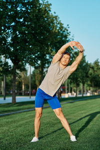 Full length of man wearing hat while sitting on grass