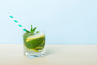 Close-up of drink in glass against white background