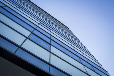 Low angle view of modern building against clear blue sky