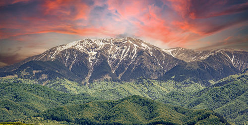 Scenic view of snowcapped mountains against sky during sunset