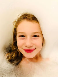 Portrait of smiling girl in bathtub
