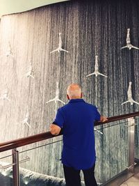 Man standing on railing