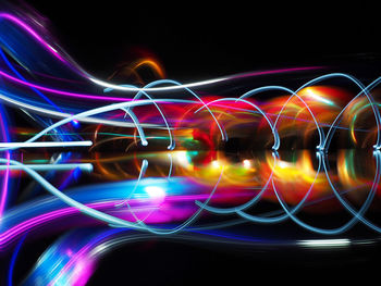 Digital composite image of light painting against black background