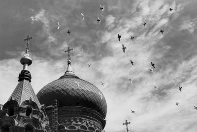 Low angle view of cathedral against cloudy sky